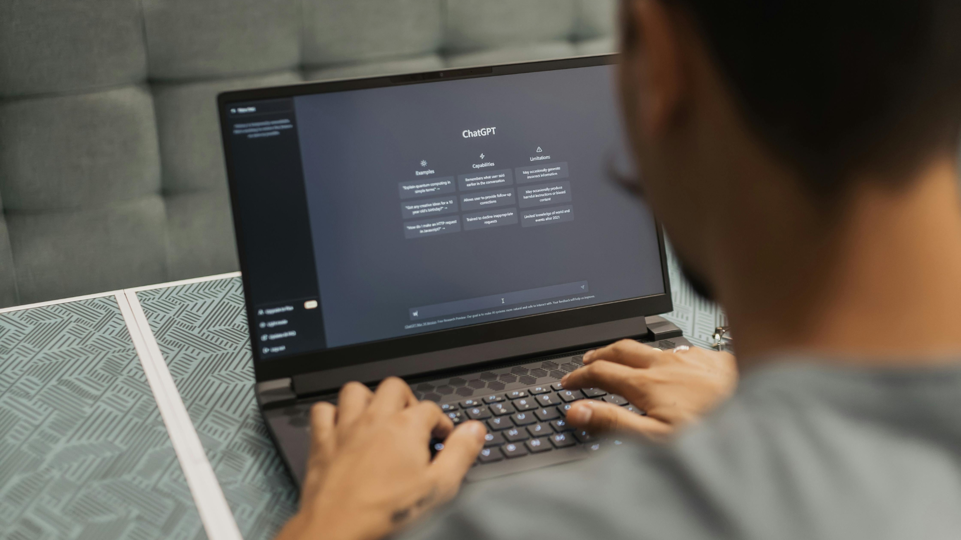A man working on his laptop, interacting with ChatGPT for support or queries.