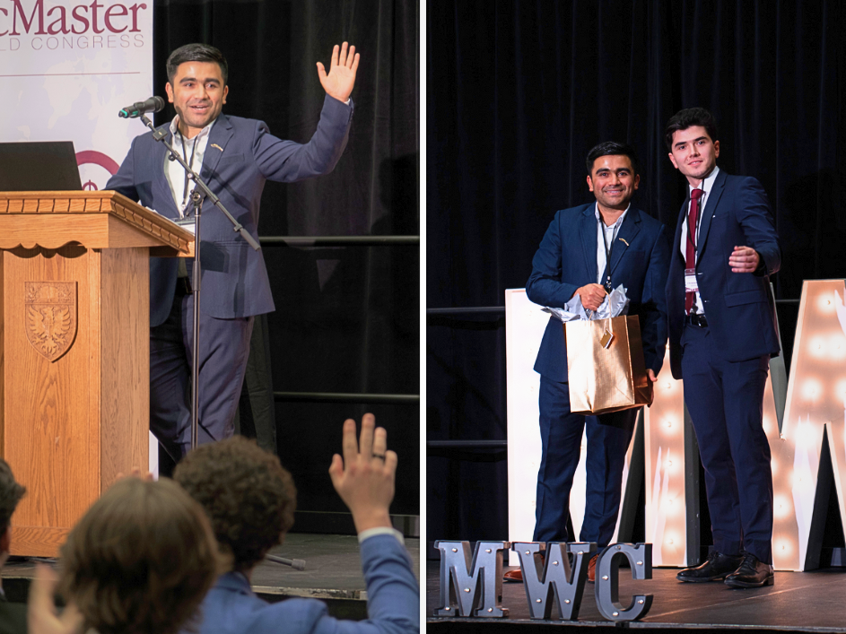 A speaker at the McMaster World Congress waves on stage while receiving a gift bag, with an audience in the background.
